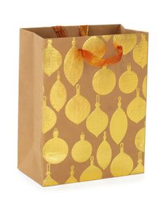 a brown paper bag with gold ornaments on it and an orange ribbon hanging from the handle