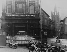 an old black and white photo shows motorcycles parked in front of a building