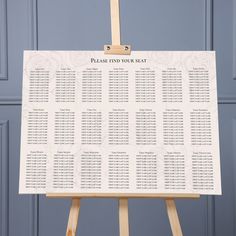 a wooden easel with a seating chart on it