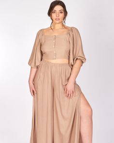 A perfect touch of elegant yet casual fashion to add to your wardrobe! This two-piece set lets you look your best while remaining comfortable. Wear this plus-size crop top and pleated maxi skirt with strappy sandals for a chic look. LuvMeMore Carolina Crop Top and Pants Set | Almond | Tops | Materials & Care Instructions: ['100% Viscose', 'Machine wash with like colors', 'Made in USA'] Almond Puff, Little Black Dress Outfit, Crop Top And Pants Set, Crop Top And Pants, Strapless Sundress, Outfit Plus Size, Classic White Shirt, Puff Sleeve Crop Top, Black Dress Outfits