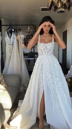 a woman standing in front of a white dress