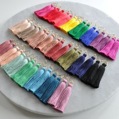 Just the pop of color you need. These hand-tied tassel earrings are made with cotton threads so they're virtually weightless. So lightweight, you might just forget you have them on. That is until you start hearing "I love your earrings!" again and again! The only problem is the 25 different colors. How will you ever choose? ;) + super lightweight cotton tassel (choose from 25 different colors) + gold-plated OR silver-plated stainless steel ear wire hooks (lead-free and nickel-free) + comes with Saree Tassels Designs, Decades Of Fashion, Gifts Under 25, Funny Earrings, Beaded Earrings Diy, I Love Your, Plastic Earrings, Long Tassel Earrings, Rainbow Jewelry