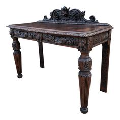 an old wooden table with ornate carvings on it