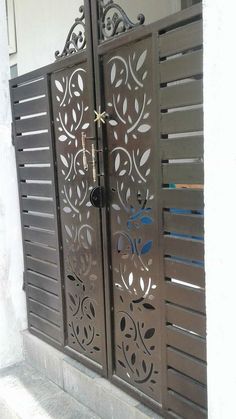 an iron gate with decorative designs on it