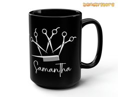 a black coffee mug with scissors and the words savannah written on it in white ink