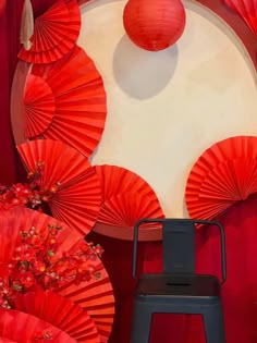 there are red paper fans on the wall