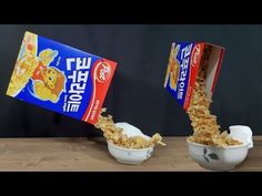 two bowls filled with cereal sitting on top of a wooden table next to each other