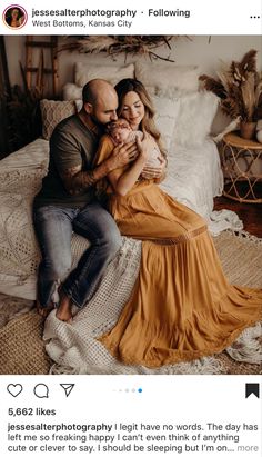 a man and woman are sitting on a bed holding their newborn baby in her arms