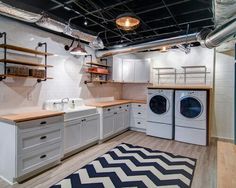 a laundry room with washer, dryer and shelves on the wall next to it