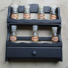 an old wooden shelf with six bottles on it