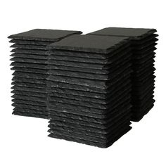 a stack of black tiles sitting on top of each other