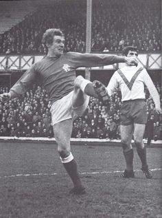 an old photo of two men playing soccer