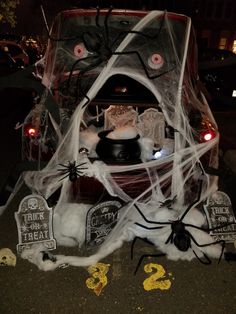 a car decorated for halloween with spider webs