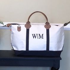 a white and blue bag sitting on top of a shelf