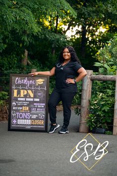 a woman standing in front of a sign