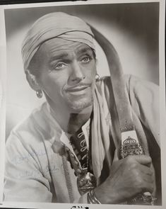 an old black and white photo of a man with a turban on his head