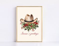 a christmas card with a cowboy's hat and holly - berry garland on it