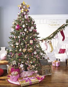 a decorated christmas tree in a living room with presents on the floor and other decorations