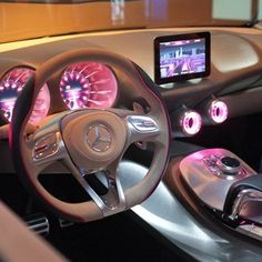 the interior of a car with electronic dashboard controls and steering wheel, including an ipod