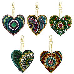 four heart shaped beaded pendants hanging from chains on a white background, each with different colors and patterns