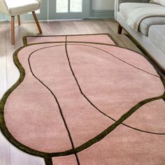 a living room with a couch, chair and rug