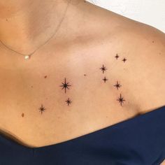 a woman's chest with small stars on it