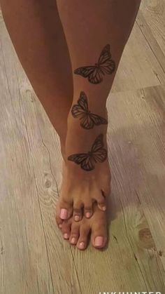 a woman's legs with butterfly tattoos on them