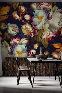 a dining room table with two chairs in front of a floral wallpapered background