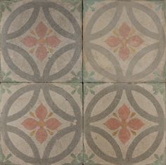 four tiles with different designs on them in grey and pink colors, one has an orange flower