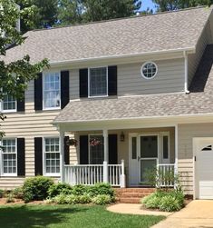 a large house with two garages in front of it