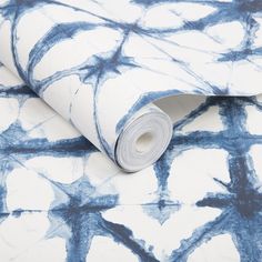 a blue and white wallpaper with an abstract design on it's surface,