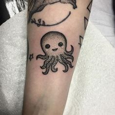 an octopus tattoo on the arm