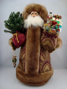 a santa clause holding a christmas tree in his hand and other decorations on the back