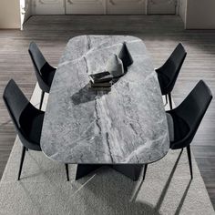 a marble table with four chairs around it