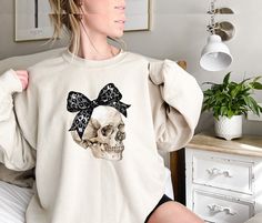 Halloween Skull Sweatshirt, Black Coquette Bow Skull Sweatshirt, Halloween Sweatshirt, Womens Halloween Sweatshirt, Funny Halloween Sweater Hi! Welcome to✨Northstar ✨ ✨As the weather gets colder, you want clothes that keep you and your body warm. Here, Northstar  is ready to keep you warm with its unique designs..✨ ✨Product Features✨ 👉Medium-heavy fabric (8.0 oz/yd² (271.25 g/m 👉Loose fit 👉Runs true to size 👉50% cotton, 50% polyester 👉Tear-away label ✨Care Instructions✨ 👉Wash item inside out in cold water, do not bleach, do not dry clean, do not iron directly on the design. ✨How To Order✨ 👉 First, please review all photos and make sure you read the descriptions. 1- Choose your size and color from the drop-down menus. 2- If you have personalization, enter the necessary information in Halloween Cotton Sweatshirt With Skull Print, Halloween Cotton Sweatshirt With Skull Design, Black Coquette, Skull Sweatshirt, Halloween Sweater, Sweatshirt Halloween, Coquette Bow, Body Warmer, Halloween Sweatshirt