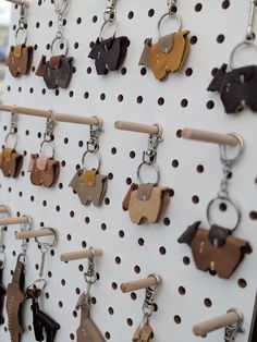 several key chains are hanging on a pegboard with dog shaped objects attached to them