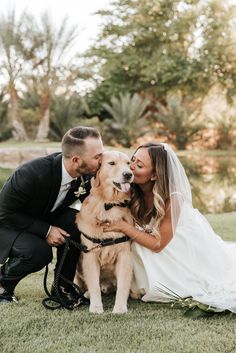 a bride and groom pose with their dog