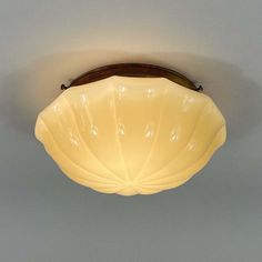 a close up of a light fixture on a ceiling in a room with gray walls