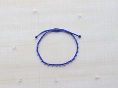 "♡Listing is for one dainty seed bead bracelet or anklet as featured and your choice of card♡ Perfect for everyday wear. Super dainty and minimalist look. Great way to add a little color to any outfit. Makes a very dainty stacking bracelet too. *Featured: Cord color- Royal Blue Beads- Periwinkle Blue Closure- B. No Beads *Material: Item is made with sturdy nylon cord. The cord resembles silk and color will not fade away. Tiny glass seed beads are carefully hand braided as the highlight of this i Minimalist Blue Beaded Bracelets, Blue Beaded Minimalist Friendship Bracelets, Minimalist Handmade Blue Friendship Bracelets, Blue Dainty Beaded Bracelets For Friendship, Blue Dainty Beaded Friendship Bracelets, Blue Minimalist Bracelets With Tiny Beads, Dainty Beaded Blue Friendship Bracelets, Dainty Blue Beaded Bracelets For Friendship, Minimalist Blue Bracelets With Tiny Beads