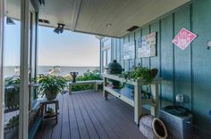 a balcony with plants and potted plants on it