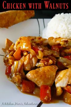 a white plate topped with chicken and veggies next to rice