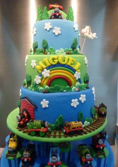 a three tiered cake with thomas the train on top