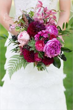 a bride holding a bouquet of flowers in her hands