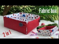 two red and white fabric storage boxes sitting on top of a table next to each other