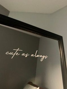 the reflection of a bed in a mirror with writing on it that says cafe as always