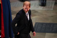 a man in a suit and tie walking down the street