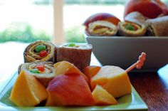 there are many different types of fruit on the plate and in the bowl next to each other