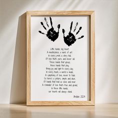 a wooden frame with two hand prints on it