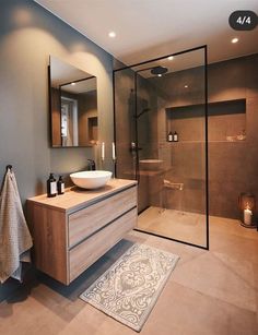 a bathroom with a sink, mirror and shower stall in it's own area