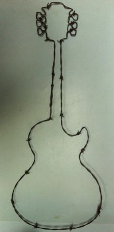 a drawing of a guitar with barbed wire on the neck and neck, in front of a white wall